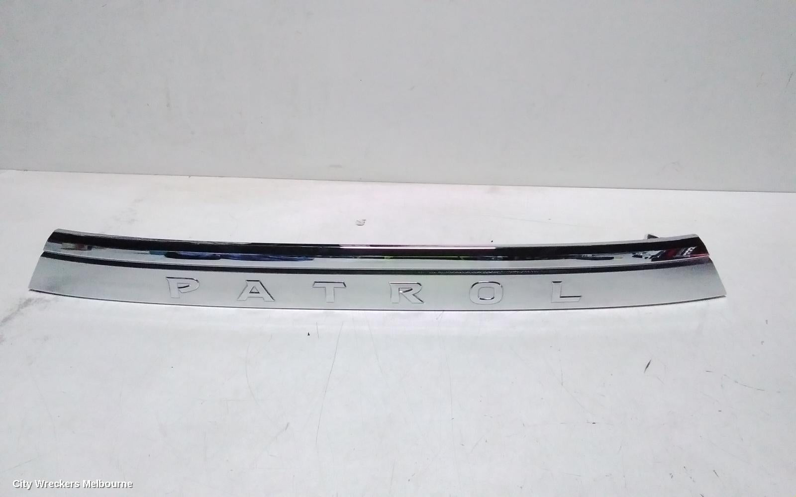 NISSAN PATROL REAR GARNISH, Y62, TAILGATE GARNISH (CENTRE), 10/2019 ONWARDS - Image 1