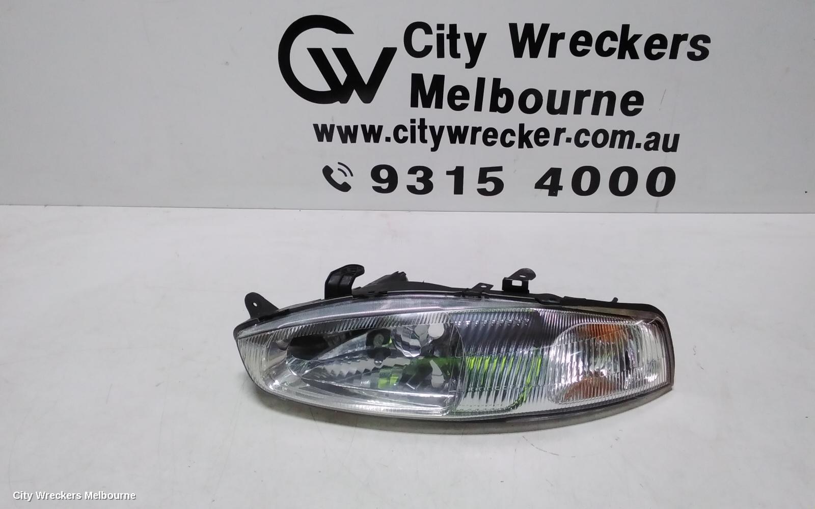 MITSUBISHI LANCER LEFT HEADLAMP, CE/CJ, LANCER (MIRAGE NZ), HATCH/COUPE, 1 PIECE W/ CORNER LAMP, PLASTIC TYPE, 07/1996 - 08/2003 - Image 1