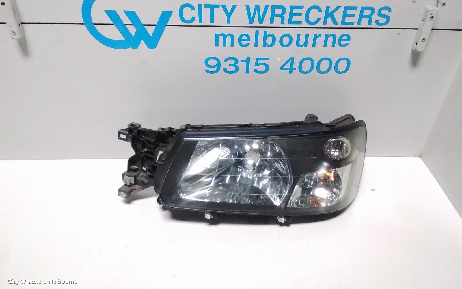 SUBARU FORESTER LEFT HEADLAMP, BLACK INSERT (CURVED LINES), LENS# 1700, 08/2004 - 05/2005 - Image 1